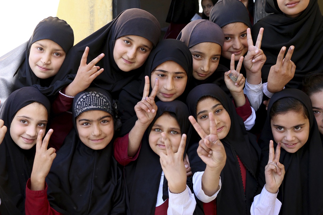 Students of the school of Nobel Peace Prize winner Malala Yousafzai flash victory sign in her hometown of Swat Valley in Pakistan.