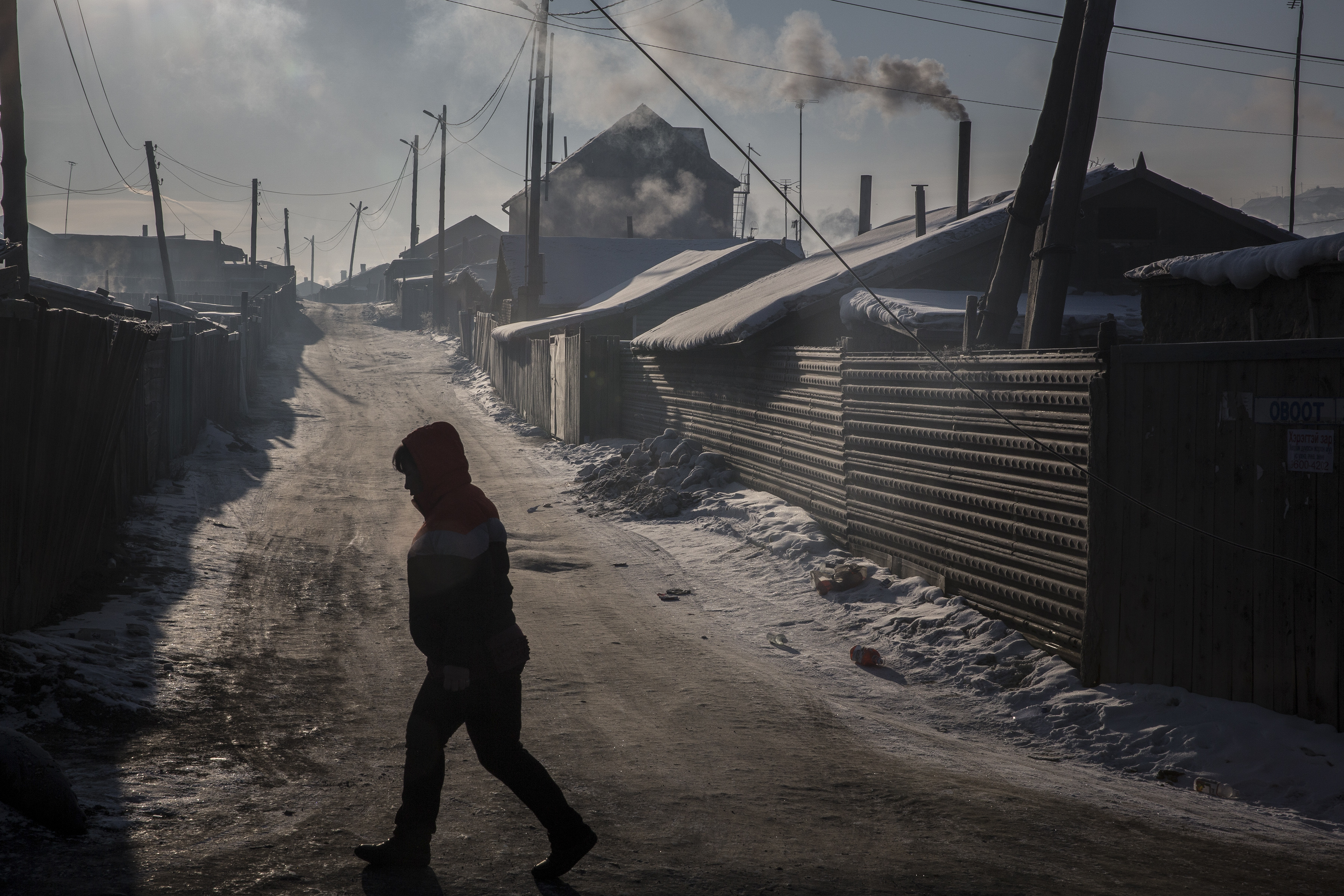 On a day of heavy pollution, a resident walks through the Bayankhoshuu District of northern Ulaanbaatar, Mongolia.