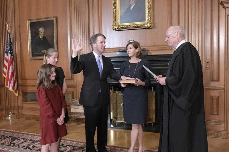 Retired Justice Anthony M. Kennedy administers the Judicial Oath to Judge Brett Kavanaugh in the Justices' Conference Room of the Supreme Court Building.