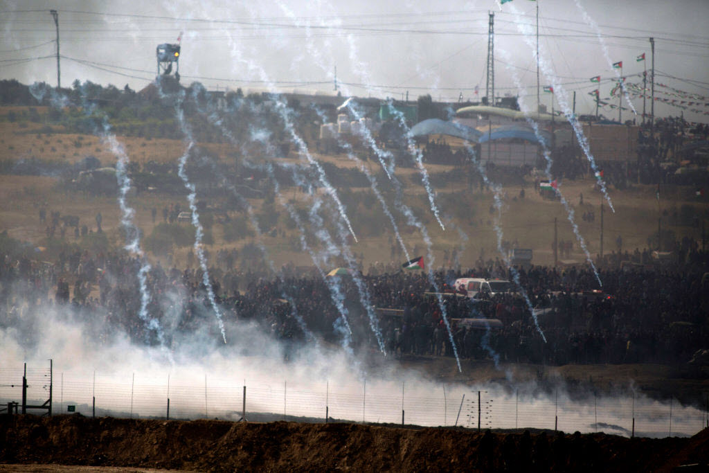 Israeli soldiers fire tear gas as Palestinian gathered for a protest on the Israel-Gaza border on April 13, 2018 in Nahal Oz, Israel. 