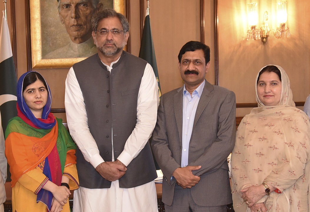 Malala Yousafzai and her parents pose for a photograph with Shahid Khaqan Abbasi, Prime Minister of Pakistan in Islamabad, Pakistan.