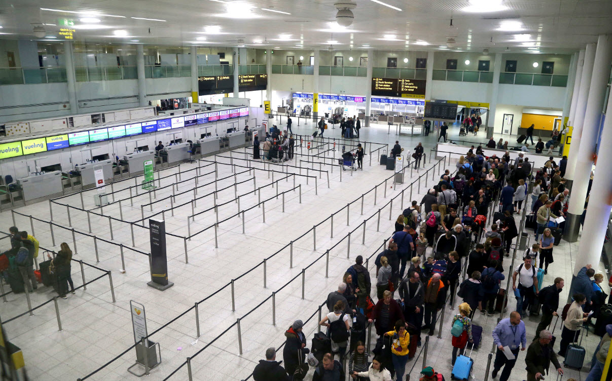 Passengers queue for flights at Gatwick Airport as the airport and airlines work to clear the backlog of flights delayed by a drone incident earlier in the week, in Crawley, England, Saturday, Dec. 22, 2018 (AAP)