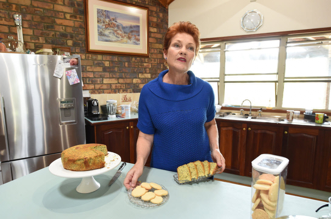 Please explain: Pauline Hanson literally feeding the chooks (AAP)