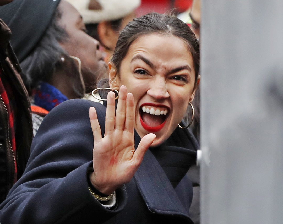 U.S. Rep. Alexandria Ocasio-Cortez, D-New York, waves to supporters as she arrives at a rally organized by Women's March NYC at Foley Square in Lower Manhattan, Saturday, Jan. 19, 2019, in New York. (AP Photo/Kathy Willens)
