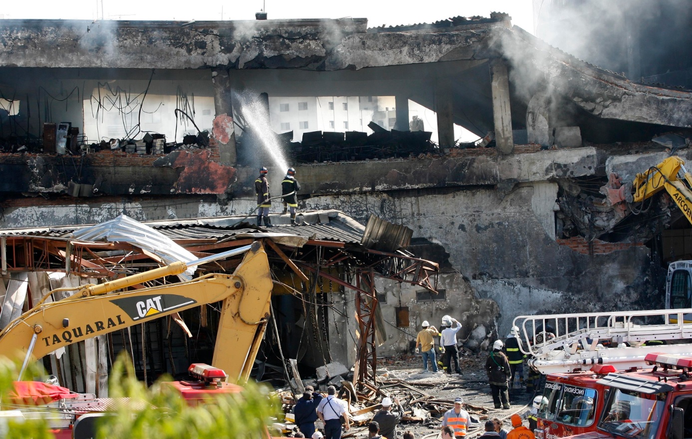Firefighters work at the site where a TAM airlines jet crashed in Sao Paulo