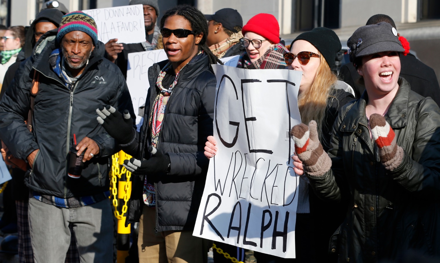 Demonstrators hold signs and chant outside the Governors office at the Capitol in Richmond, Va., Saturday, Feb. 2, 2019.