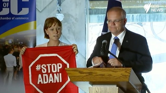 A Stop Adani protester takes to the stage