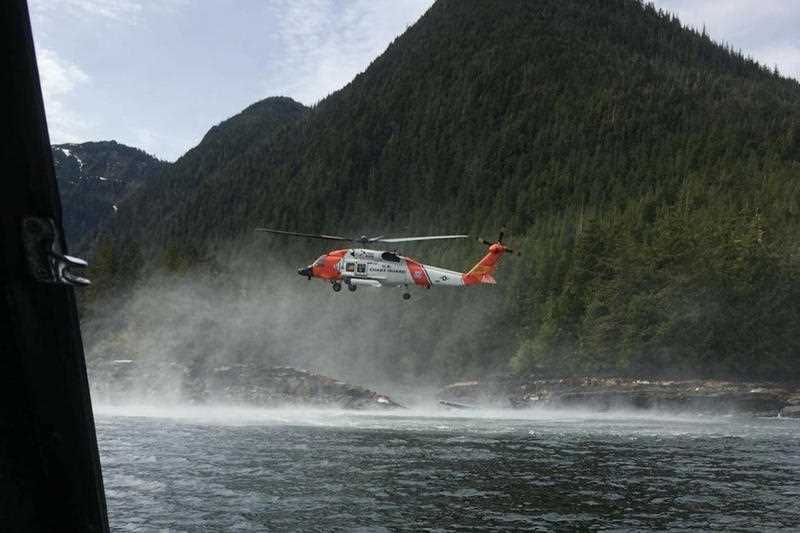 A Coast Guard helicopter searches for an Australian and a Canadian, who were initially missing. 