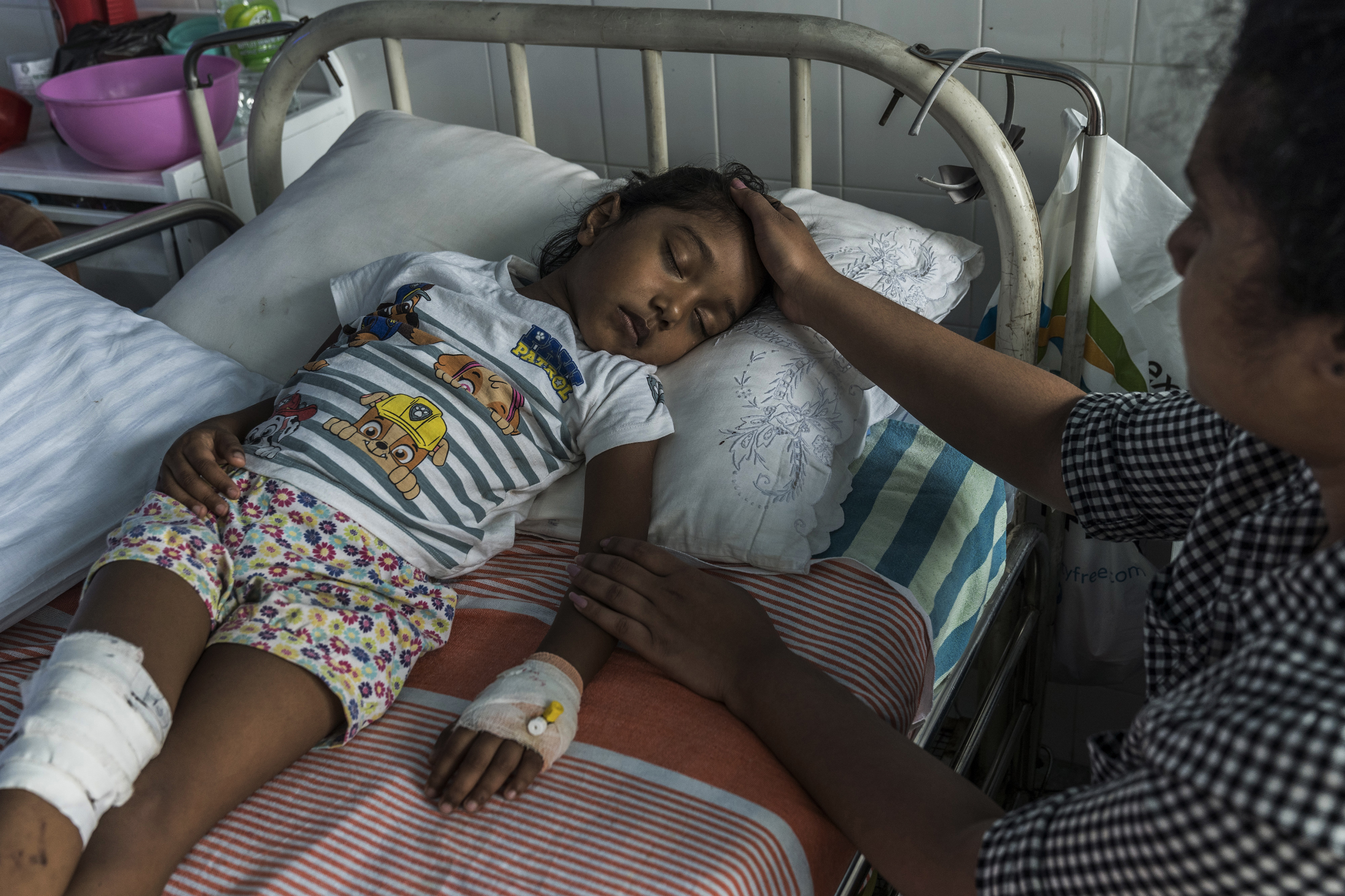 S. Diduni Nihansa, who was wounded in the Easter Sunday bombing at St. Sebastians Church, is comforted by a relative in a hospital in Colombo, Sri Lanka.