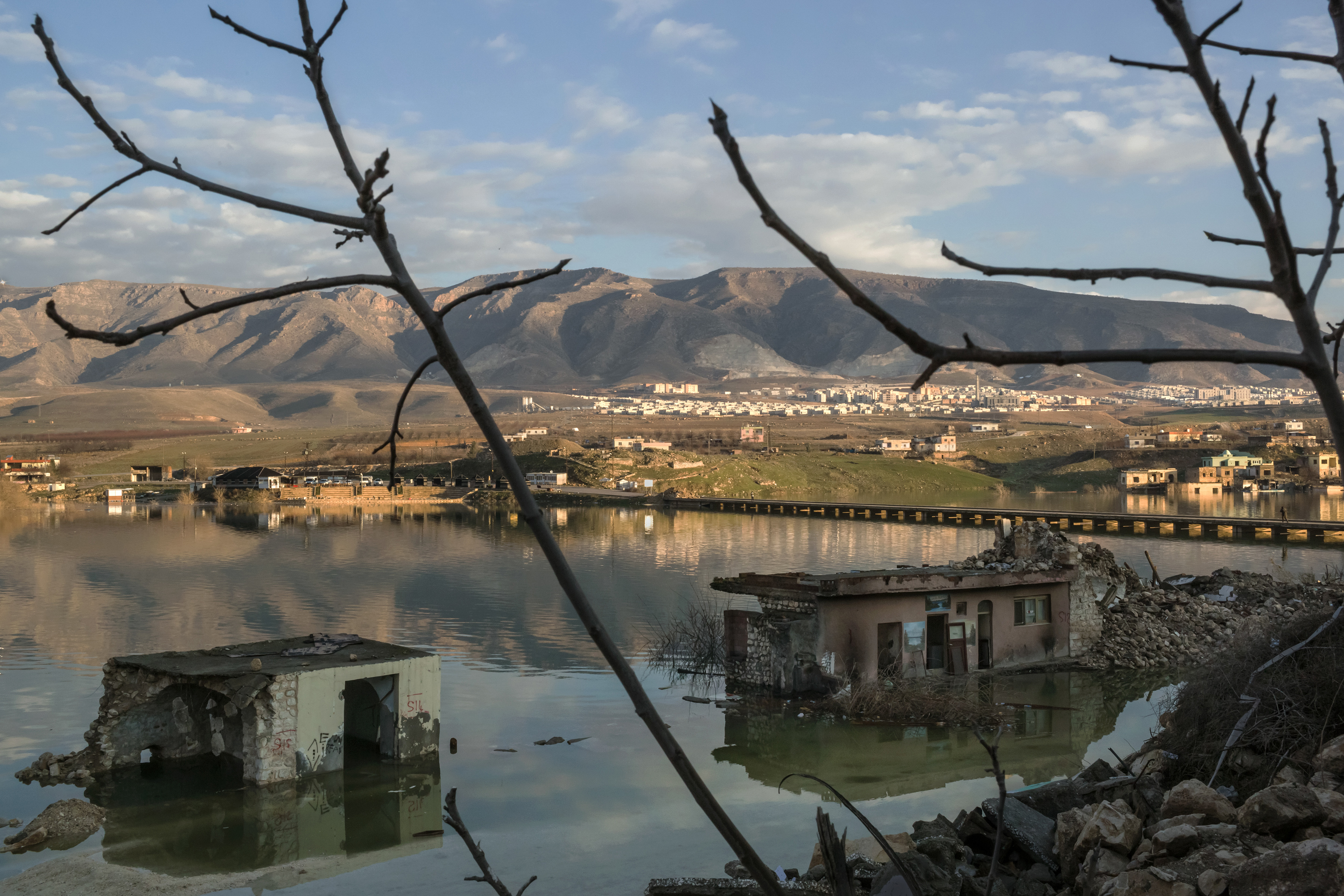 The rising waters of the Tigris River floods the old town of Hasankeyf, Turkey, with he new town in the background, Feb. 23, 2020. 
