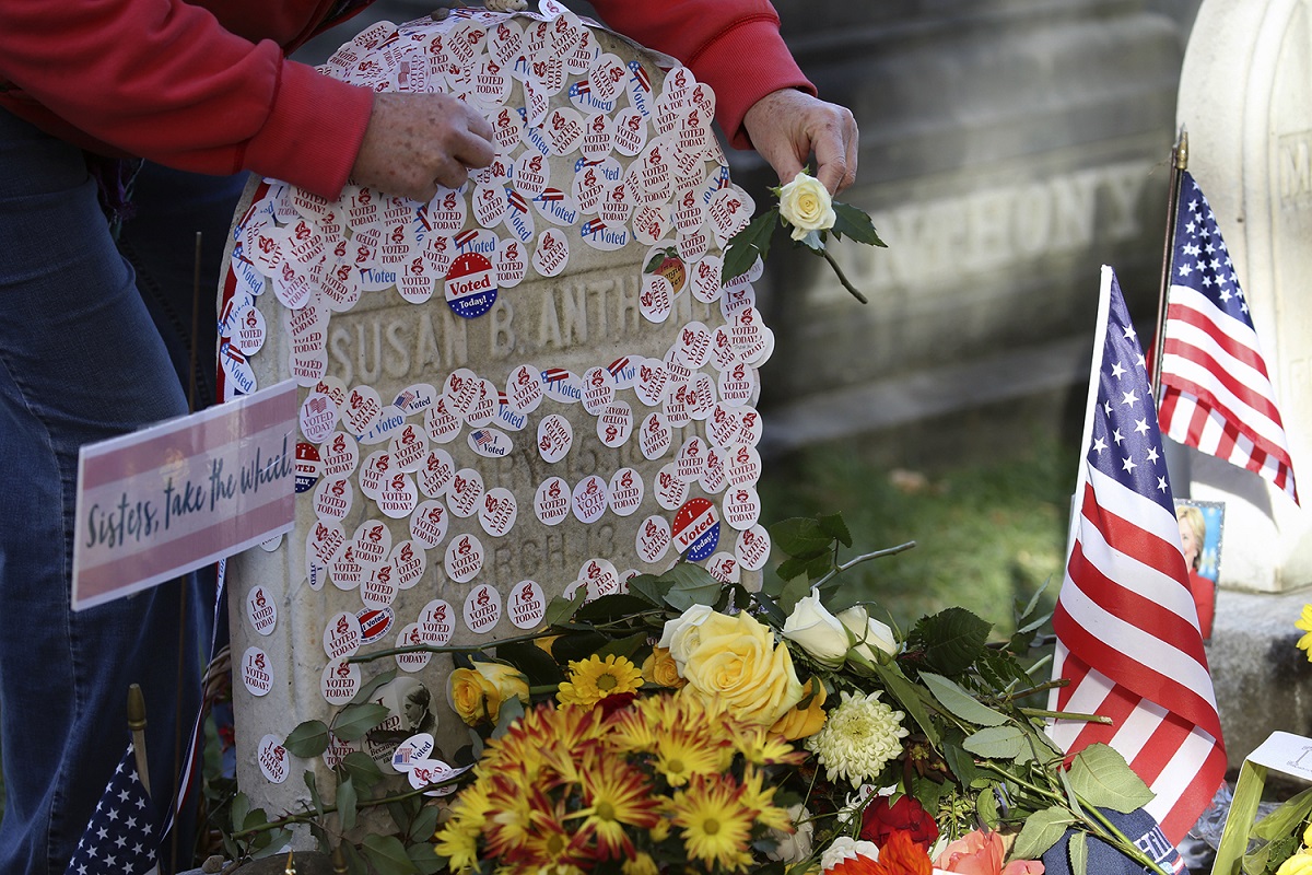 Voters lined up on Election Day to place "I voted" stickers on the grave of Susan B. Anthony in 2016. 