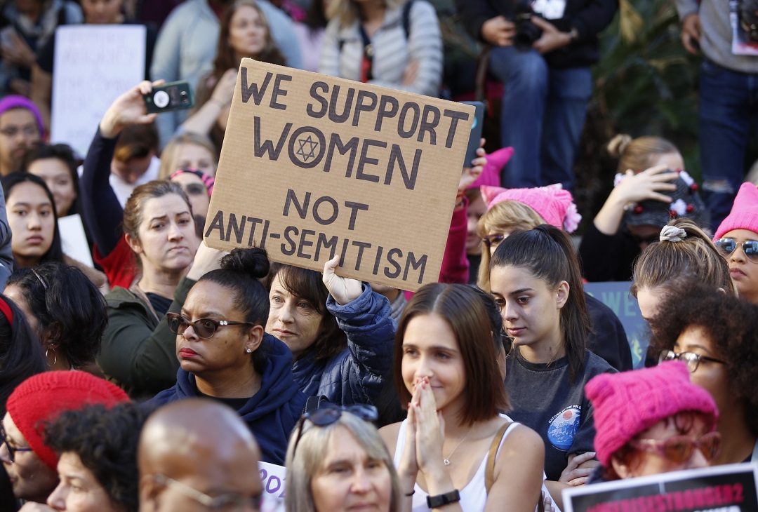 A demonstrators holds a sign against "Anti-Semitism" as she joins the Women's March in Los Angeles on Saturday, Jan. 19, 2019. (AP Photo/Damian Dovarganes)