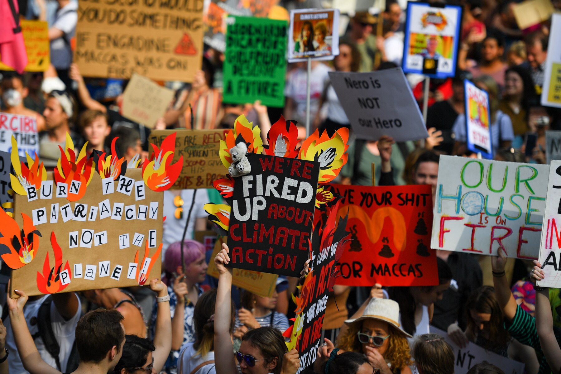 FILE - Protesters hold placards during a 'Sack ScoMo!' climate change rally in Sydney, Friday, January 10, 2020. (AAP Image/Steven Saphore) NO ARCHIVING