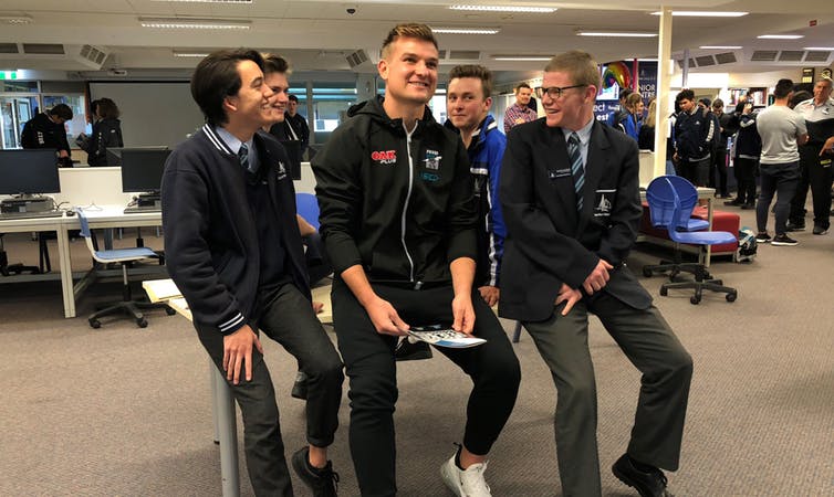 Port Adelaide Player Ambassador Ollie Wines with students as part of the Power to End Violence Against Women program.