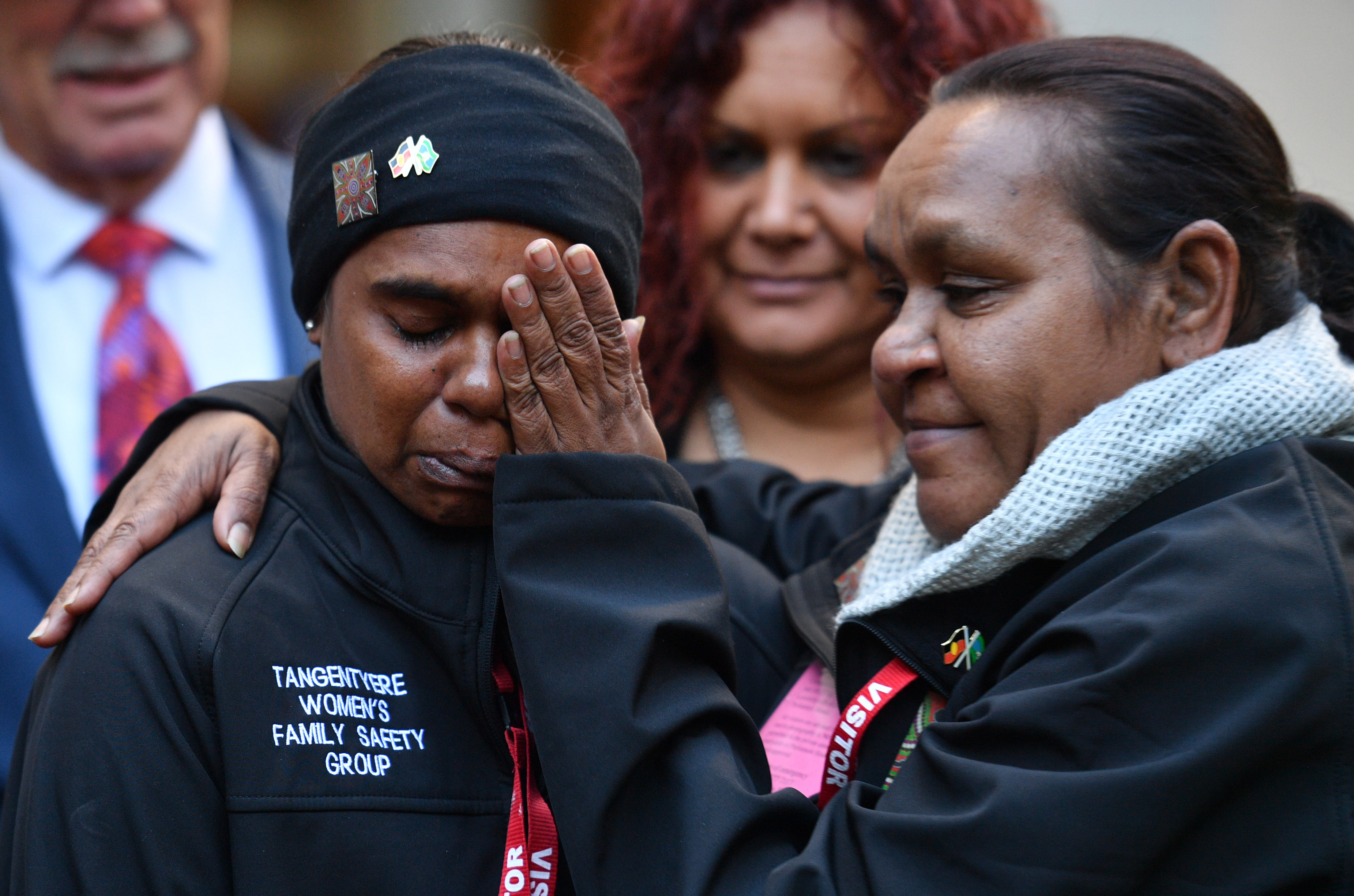 Barbara Shaw (R) consoles Shirleen Campbell of the Tangentyere Women's Family Safety Group from Alice Springs at an event to discuss combatting family violence at Parliament House in Canberra, Tuesday, March 27, 2018. (AAP Image/Mick Tsikas) NO ARCHIVING