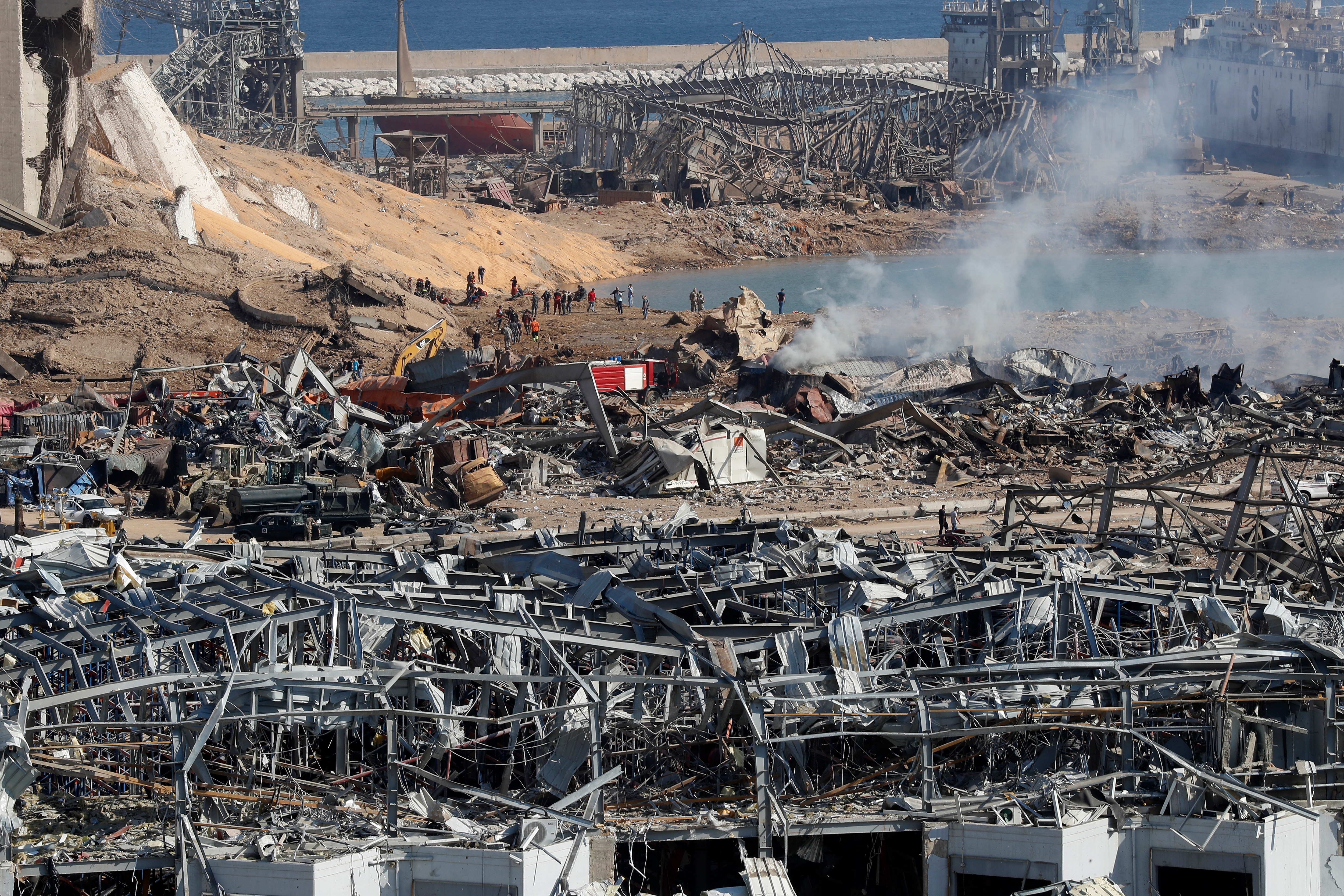 Rescue workers and security officers work at the scene of an explosion that hit the seaport of Beirut, Lebanon.