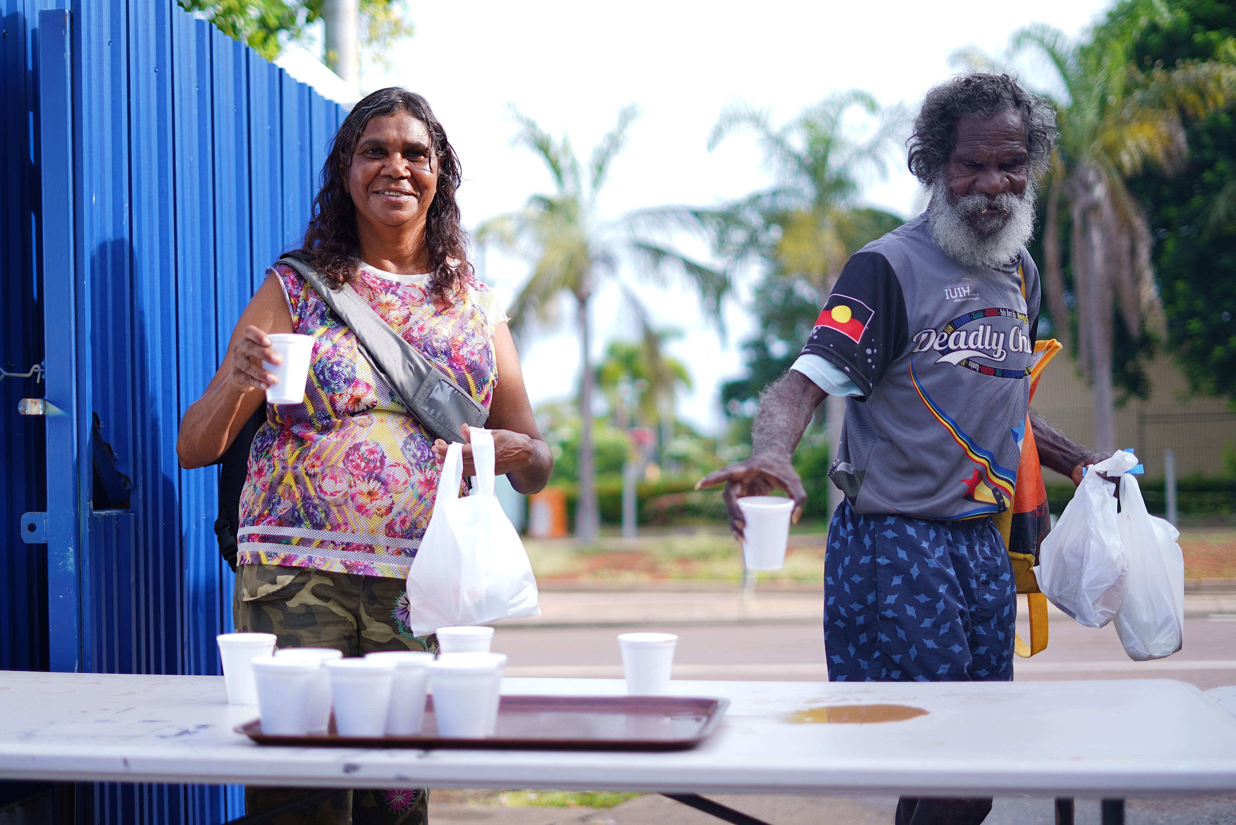 Two people from the long grass community grab breakfast