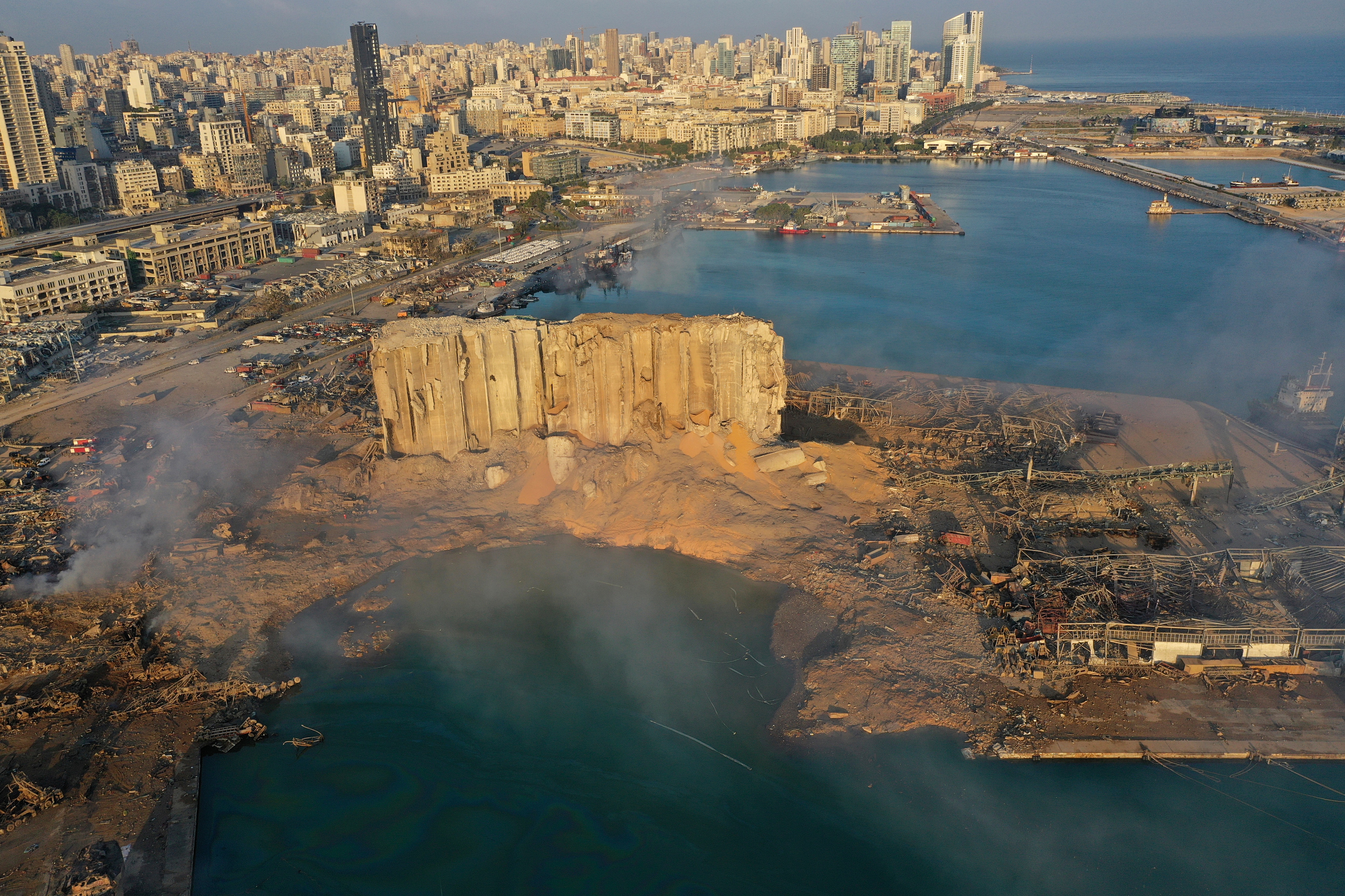 Smoke rises from the scene of an explosion that hit the seaport of Beirut, Lebanon, Wednesday, Aug. 5, 2020. (AP Photo/Hussein Malla)
