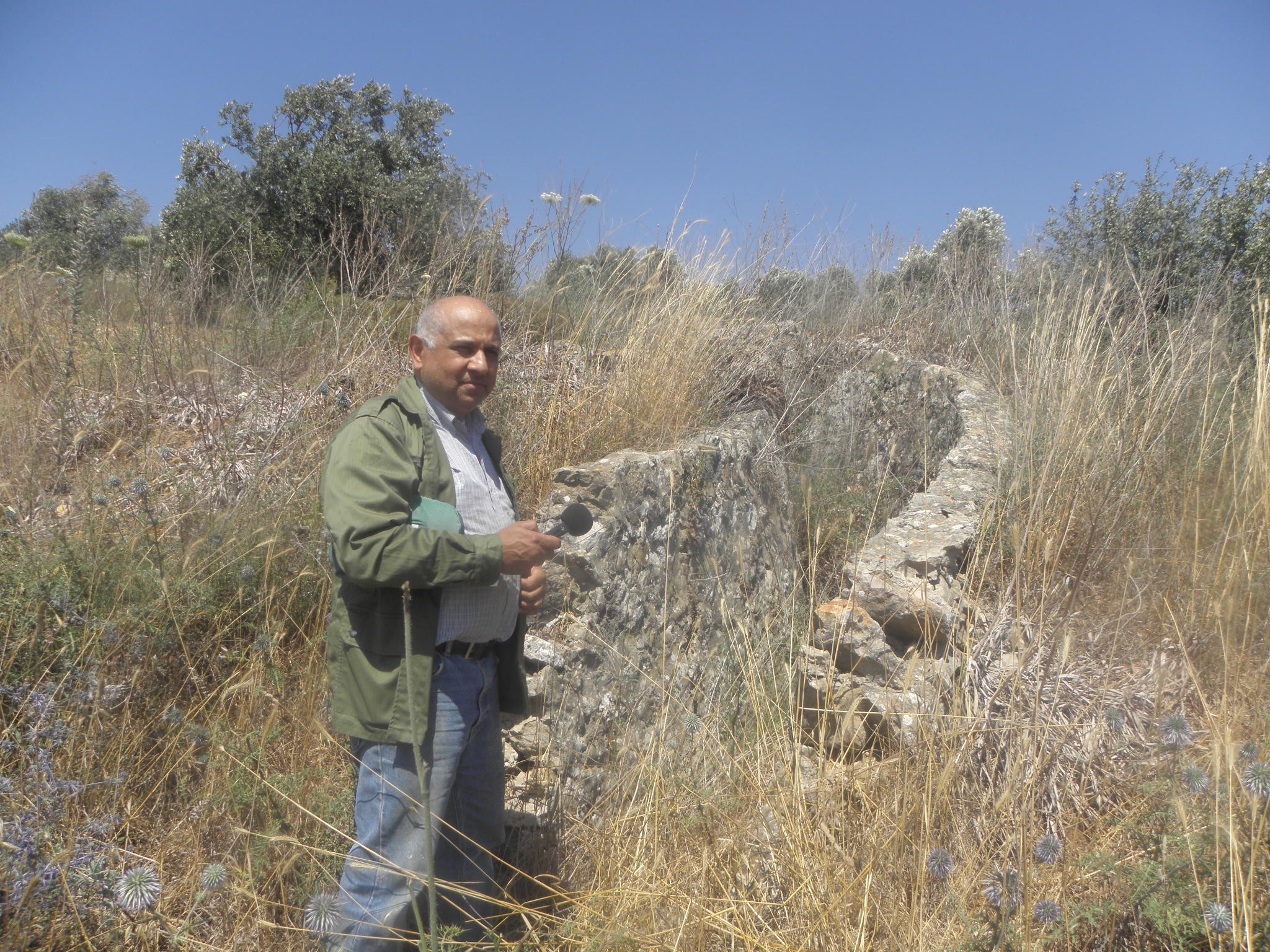 Dr Yousuf Hijazi standing alongside what remains of a structure he believes was created by Australian soldiers.