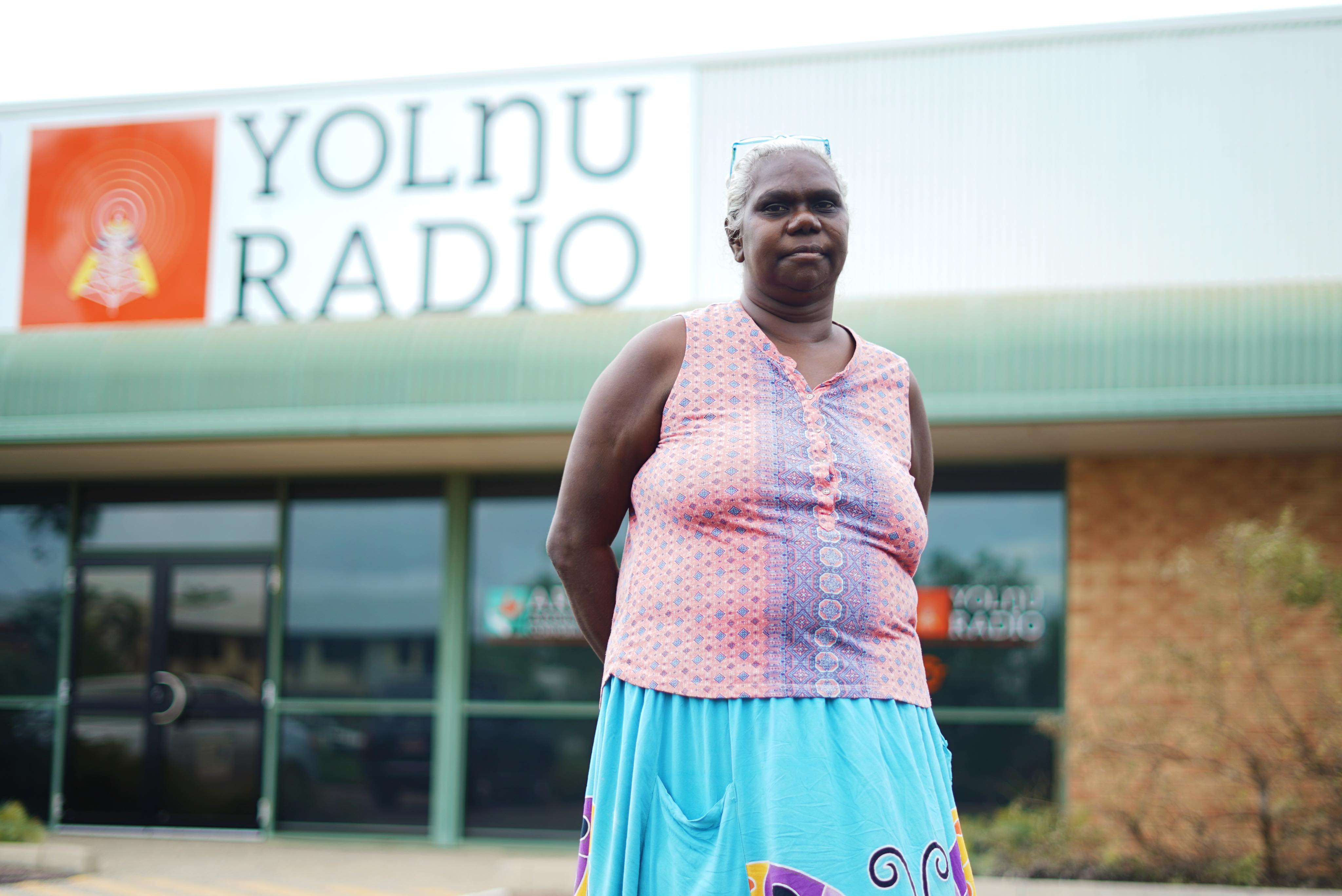 Sylvia Nulpinditj standing in front of the Yolngu Radio Station