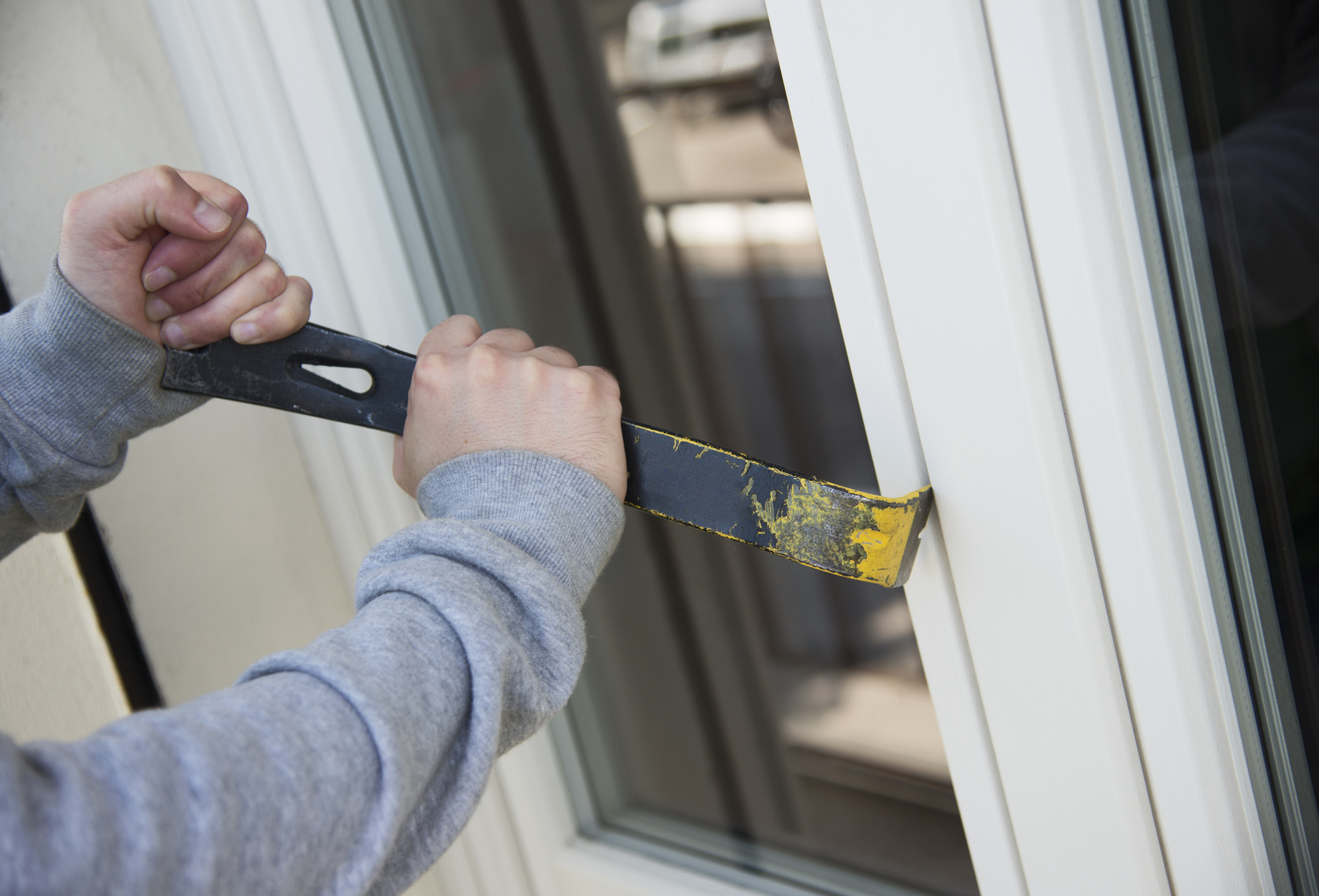 bad thief breaking a window for stealing