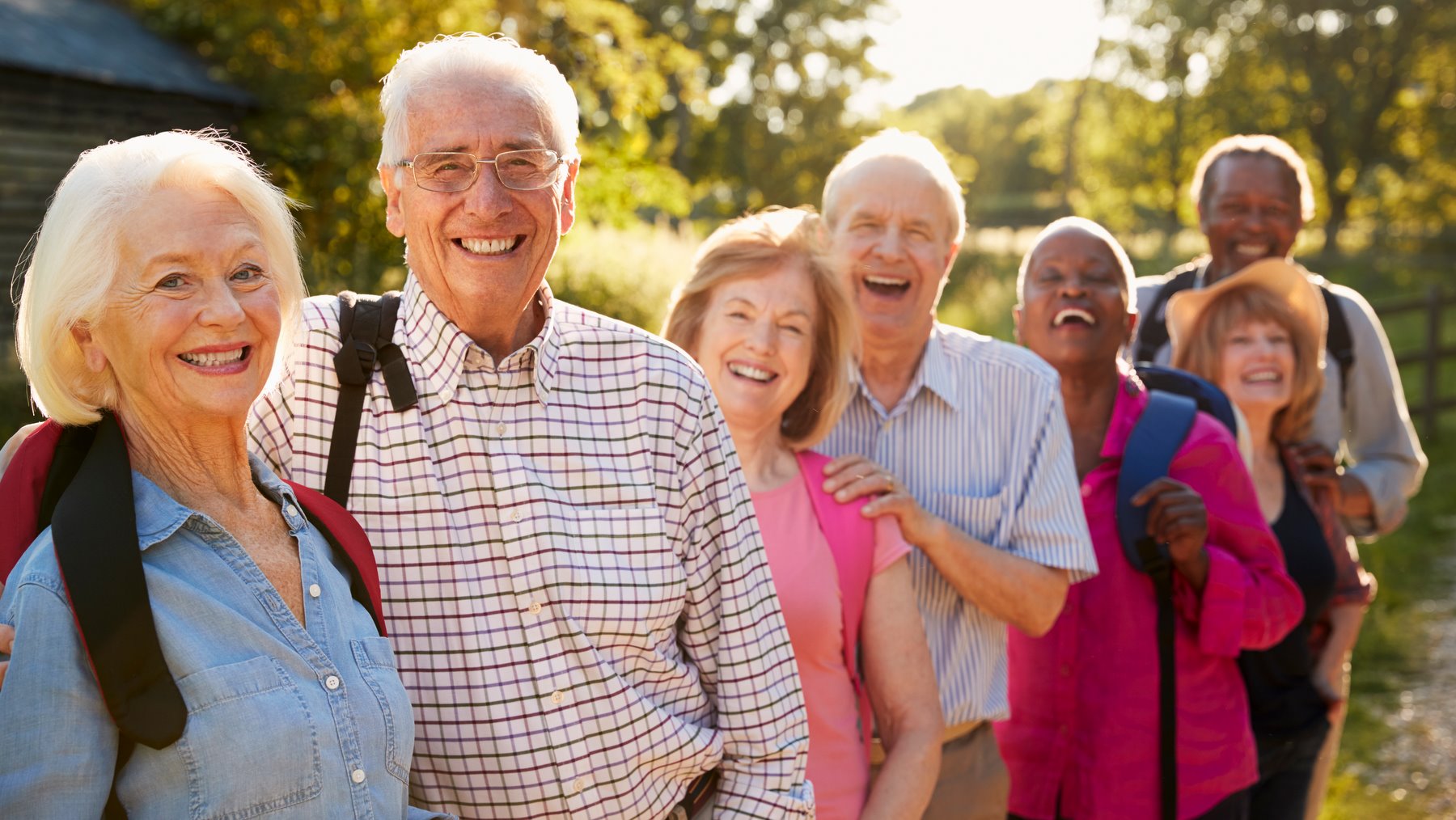 Portrait Of Senior Friends Hiking In Countryside