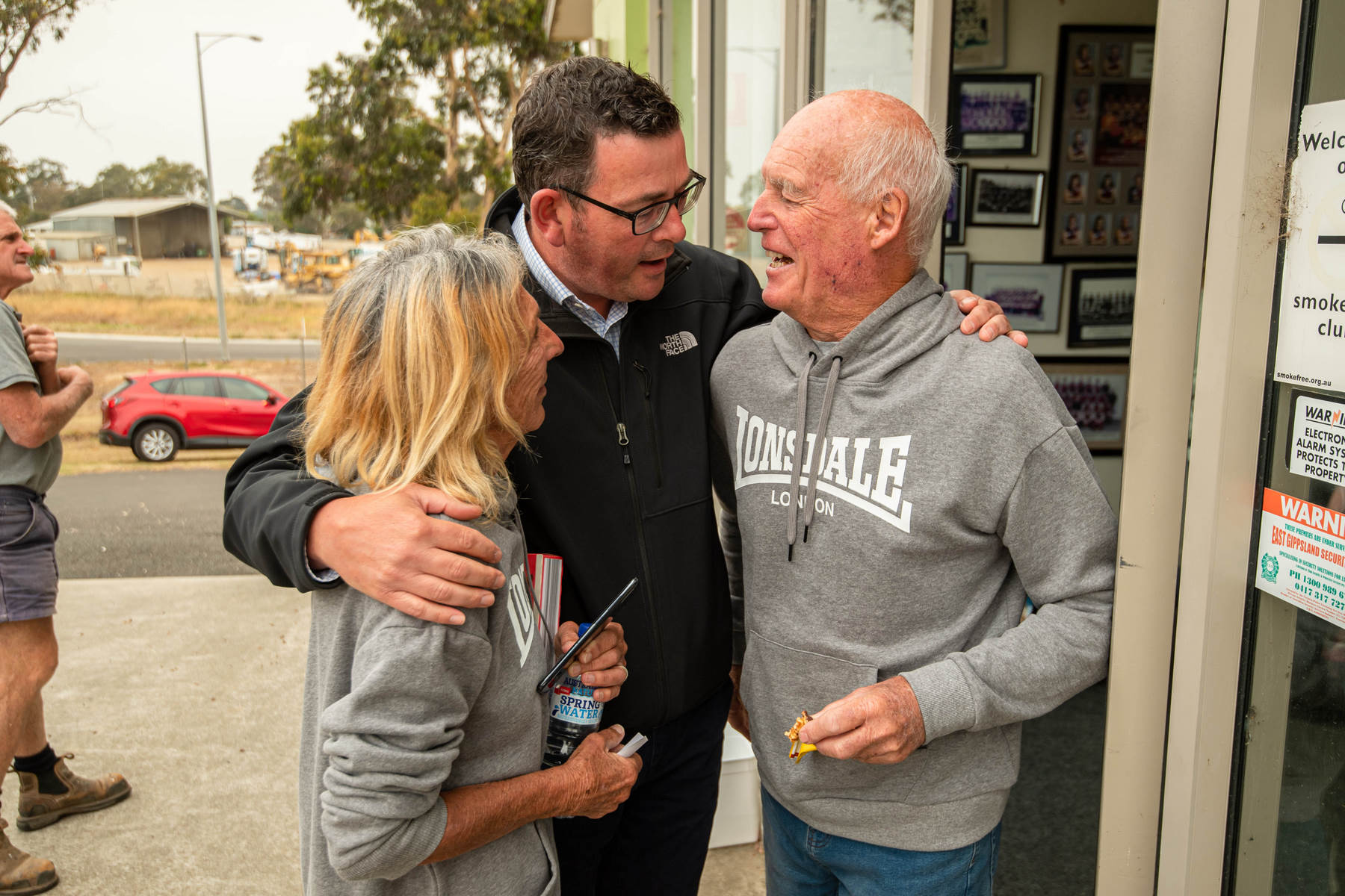 Vic Premier Daniel Andrews with a couple who lost their business in the fires in East Gippsland