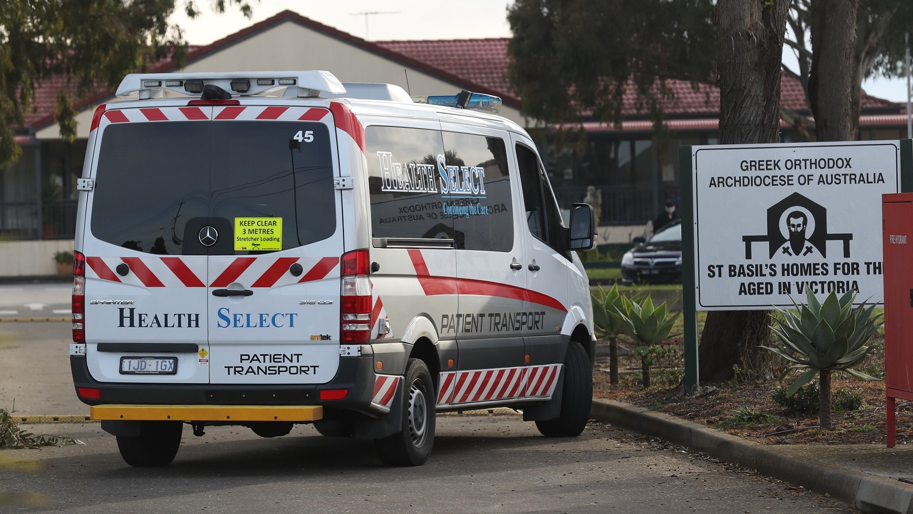 Medical staff are seen preparing to transport people from the St Basils Home for the Aged Care in Fawkner which has had an outbreak of COVID-19.