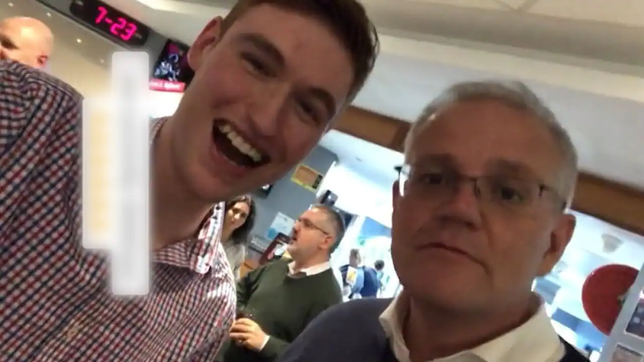 activist smiling takes selfie with Scott Morrison